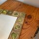 Vintage 1960s green and brown glazed ceramic mirror.