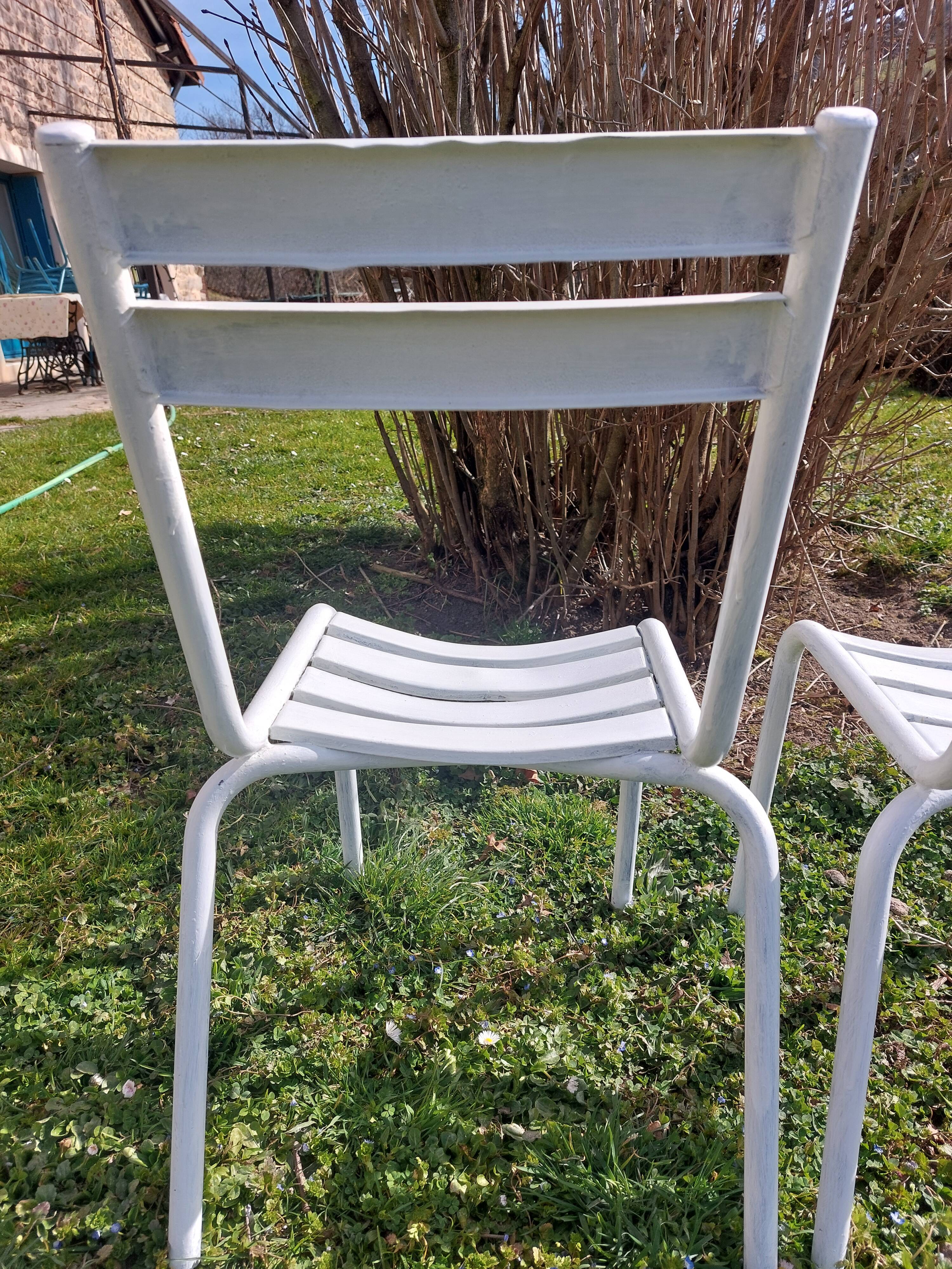 pair of white metal chairs, Tolix style