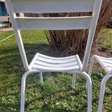 pair of white metal chairs, Tolix style