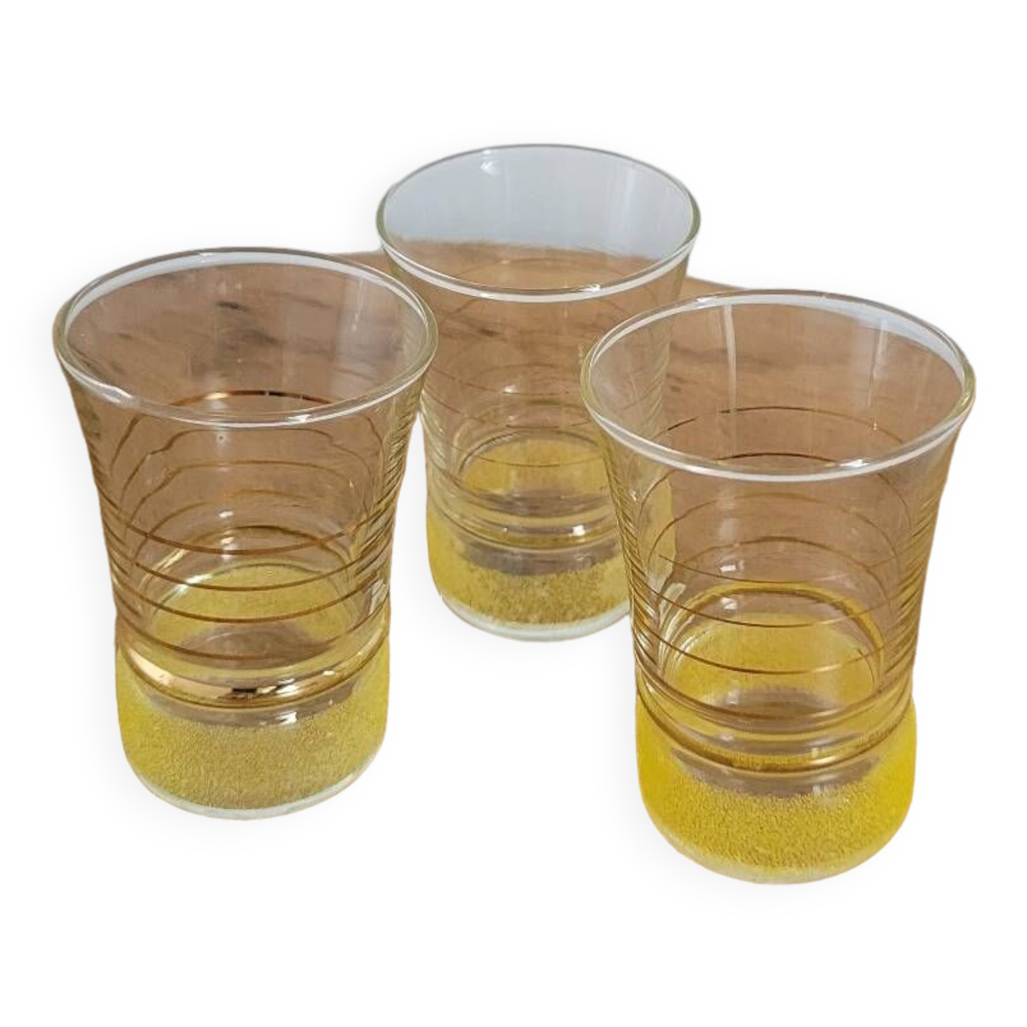 Trio of small yellow granite glasses with gold rims