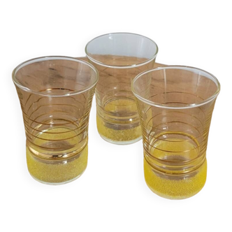 Trio of small yellow granite glasses with gold rims