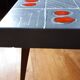 Small 1960s enamelled table, spindle legs, signed jd.