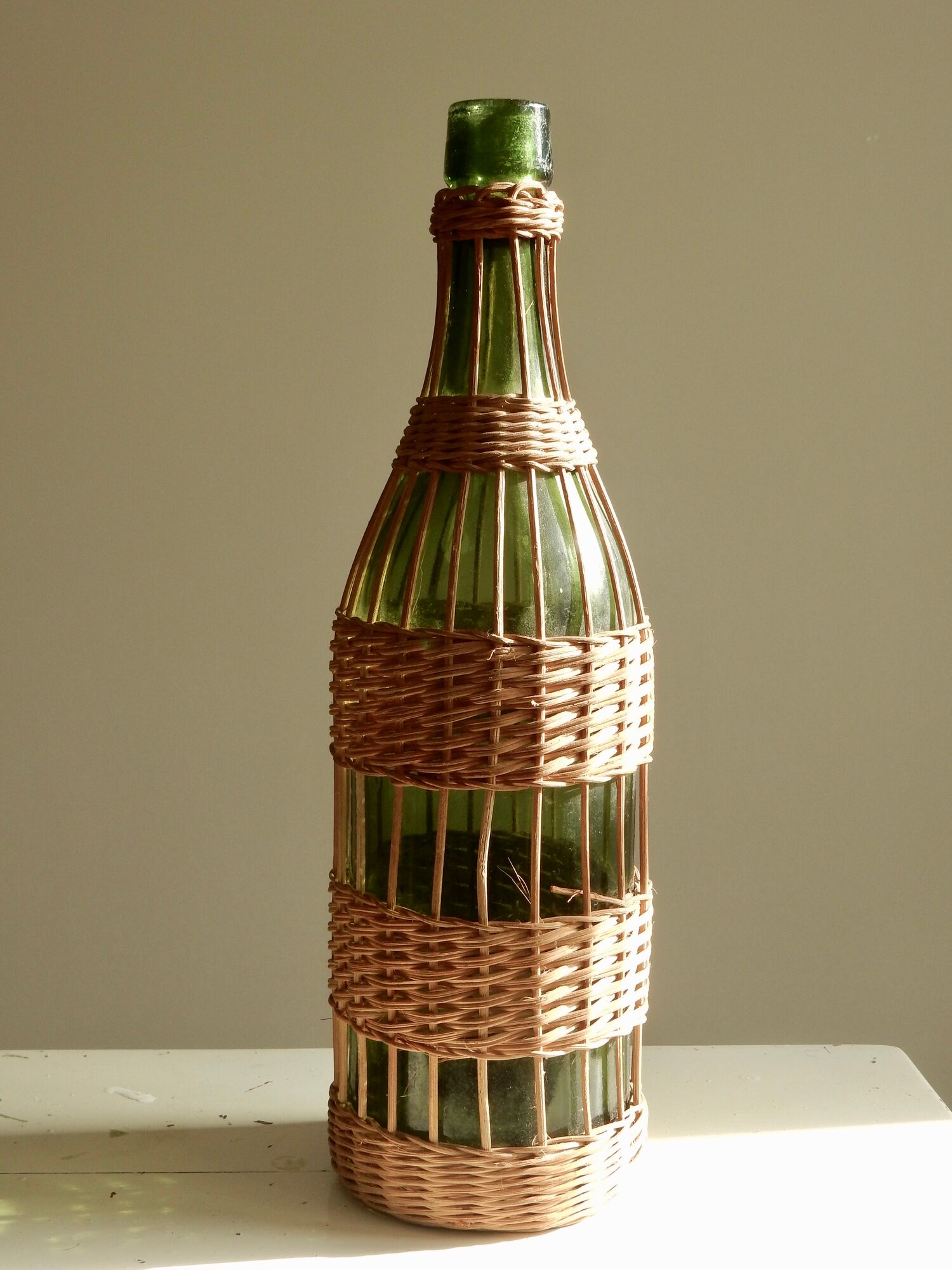 Glass bottle covered with wicker, France of the 60
