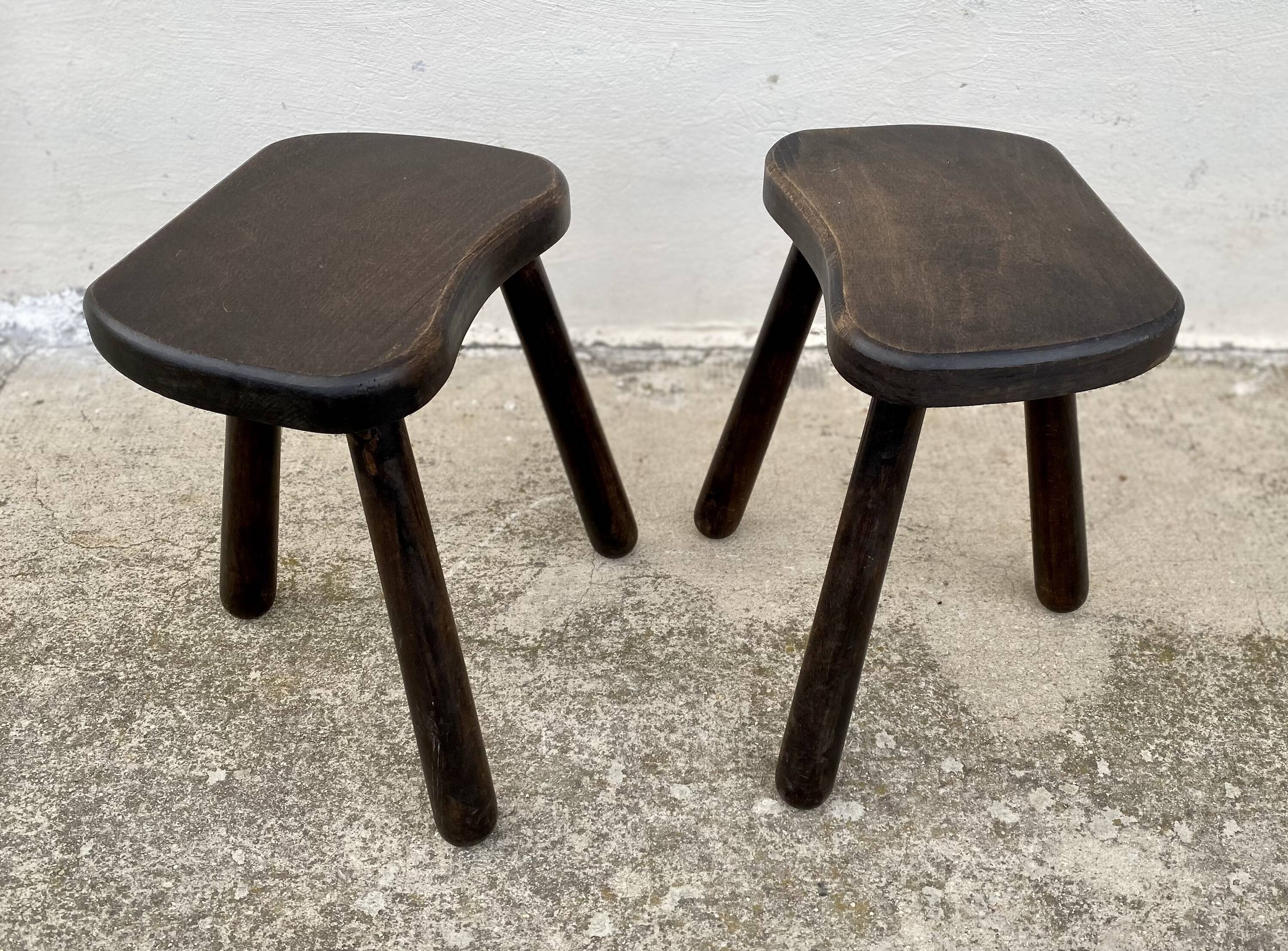 Pair of vintage stained wood tripod stools from the 1970s