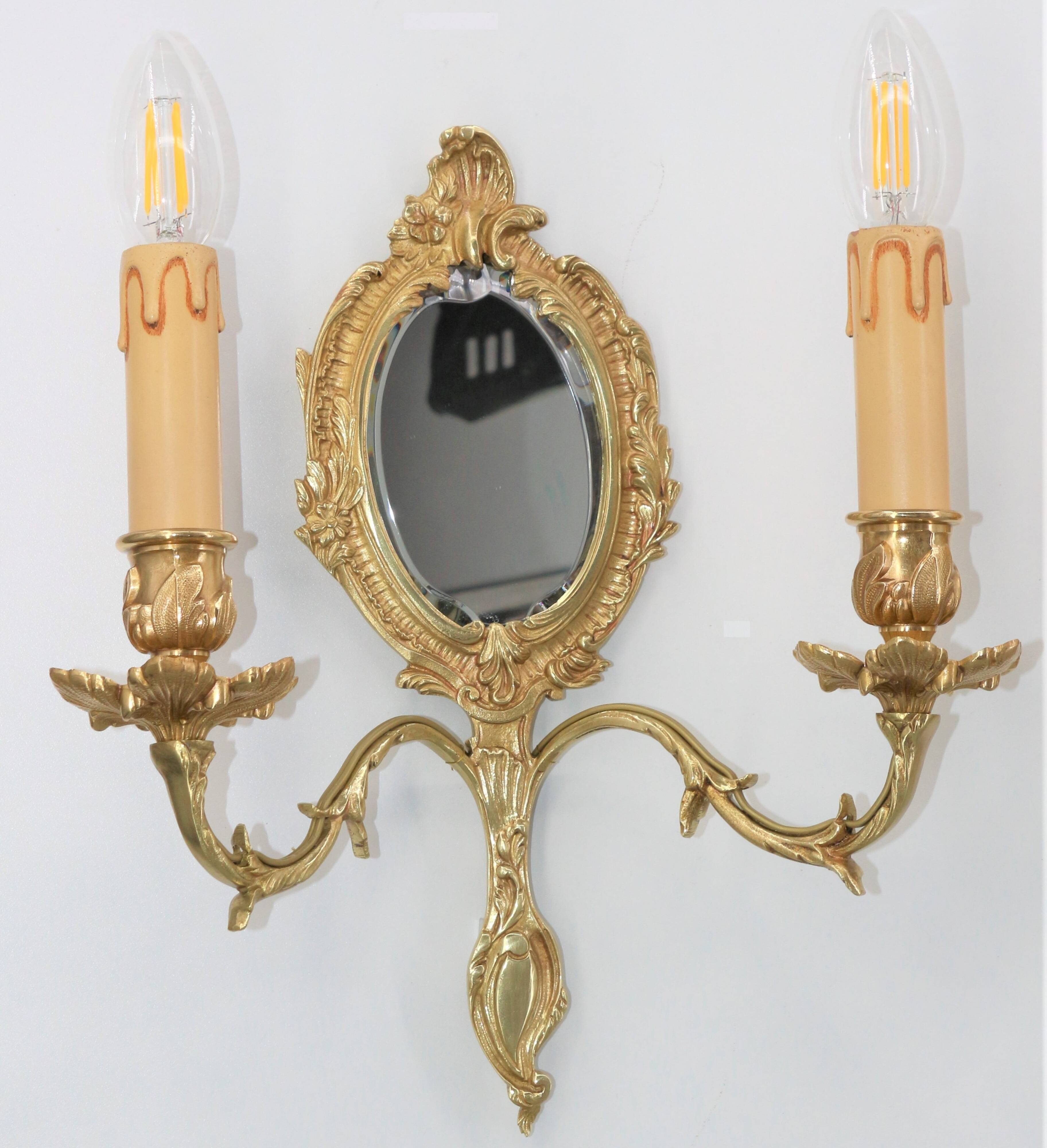 Pair of Louis XV style beveled mirror sconces in bronze by Lucien Gau