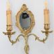 Pair of Louis XV style beveled mirror sconces in bronze by Lucien Gau