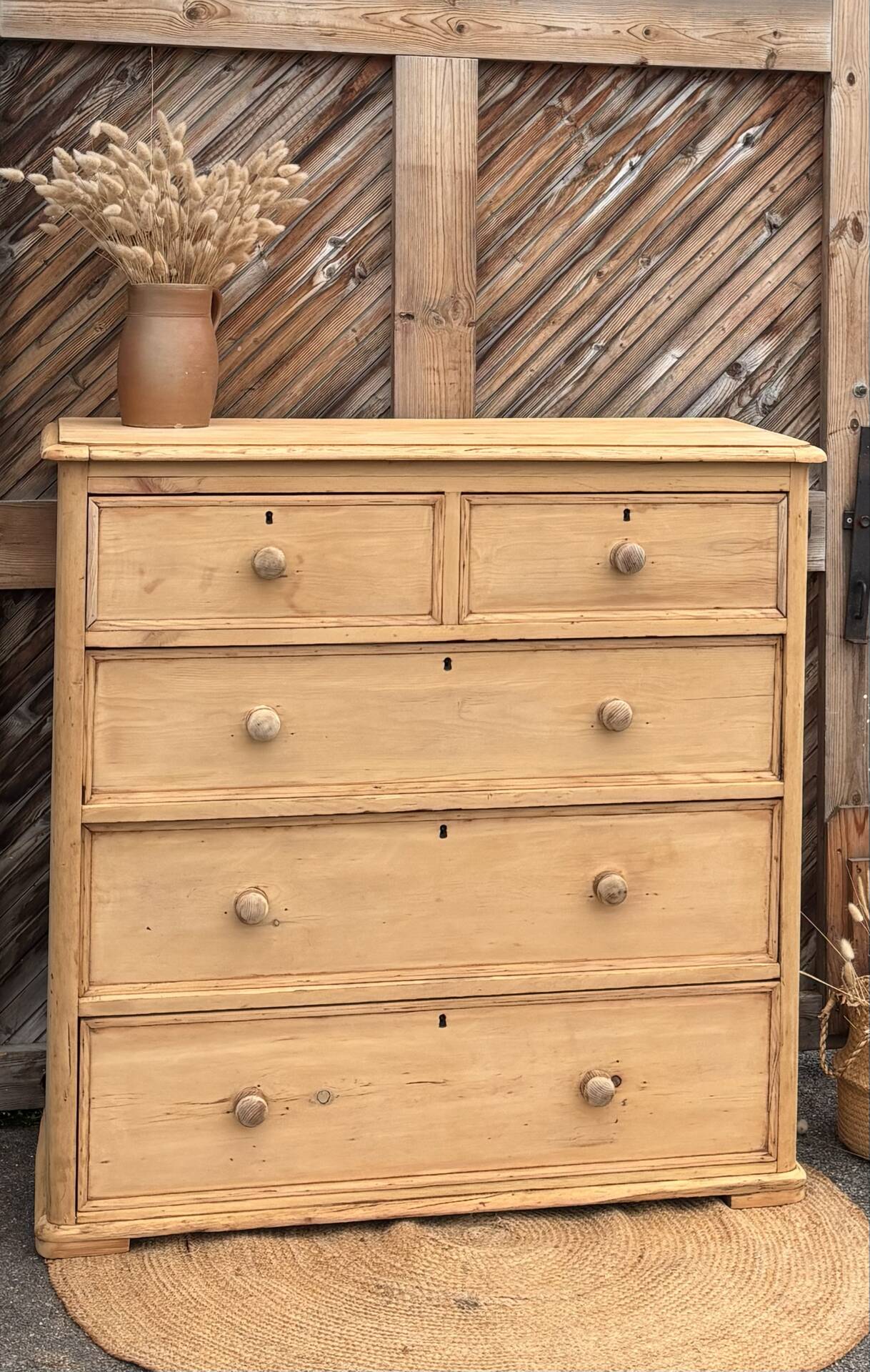 Large antique English chest of drawers in raw solid wood.
