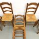 Set of 8 chairs in solid elm with straw seats.