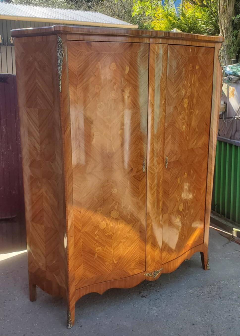 Two-door cabinet with marquetry floral design from the early 20th century.