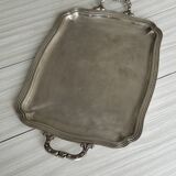 Silver metal serving tray with sculpted handles