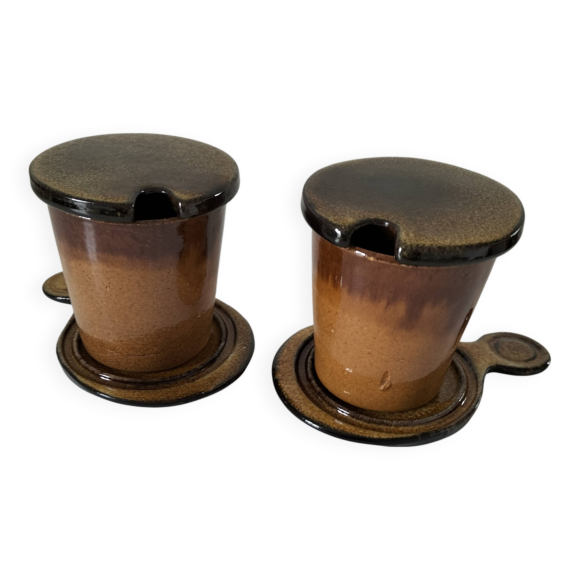 Pair of glazed stoneware cups with saucers and lids