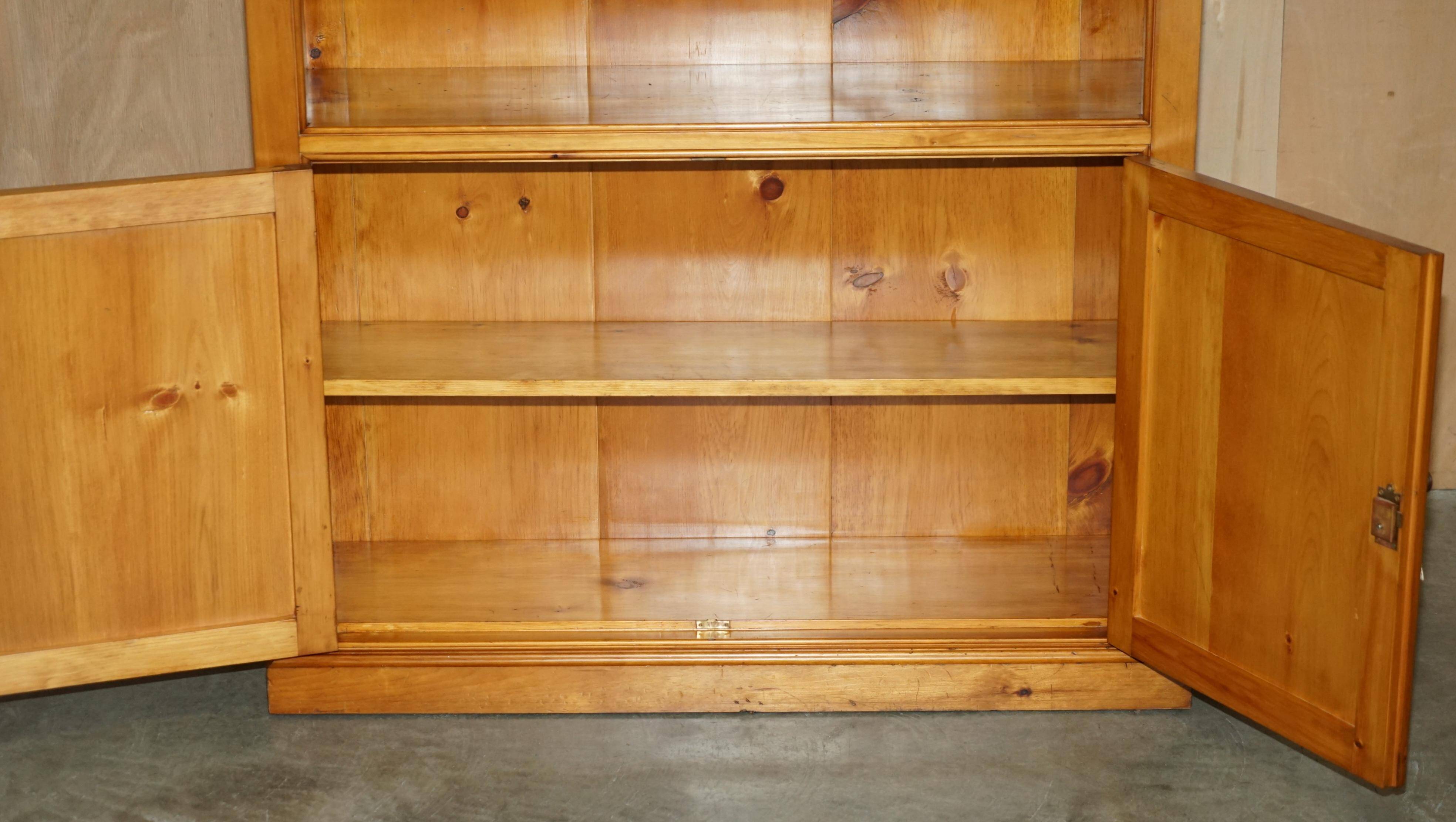 Pair of vintage cherry wood bookcases with lockable doors.