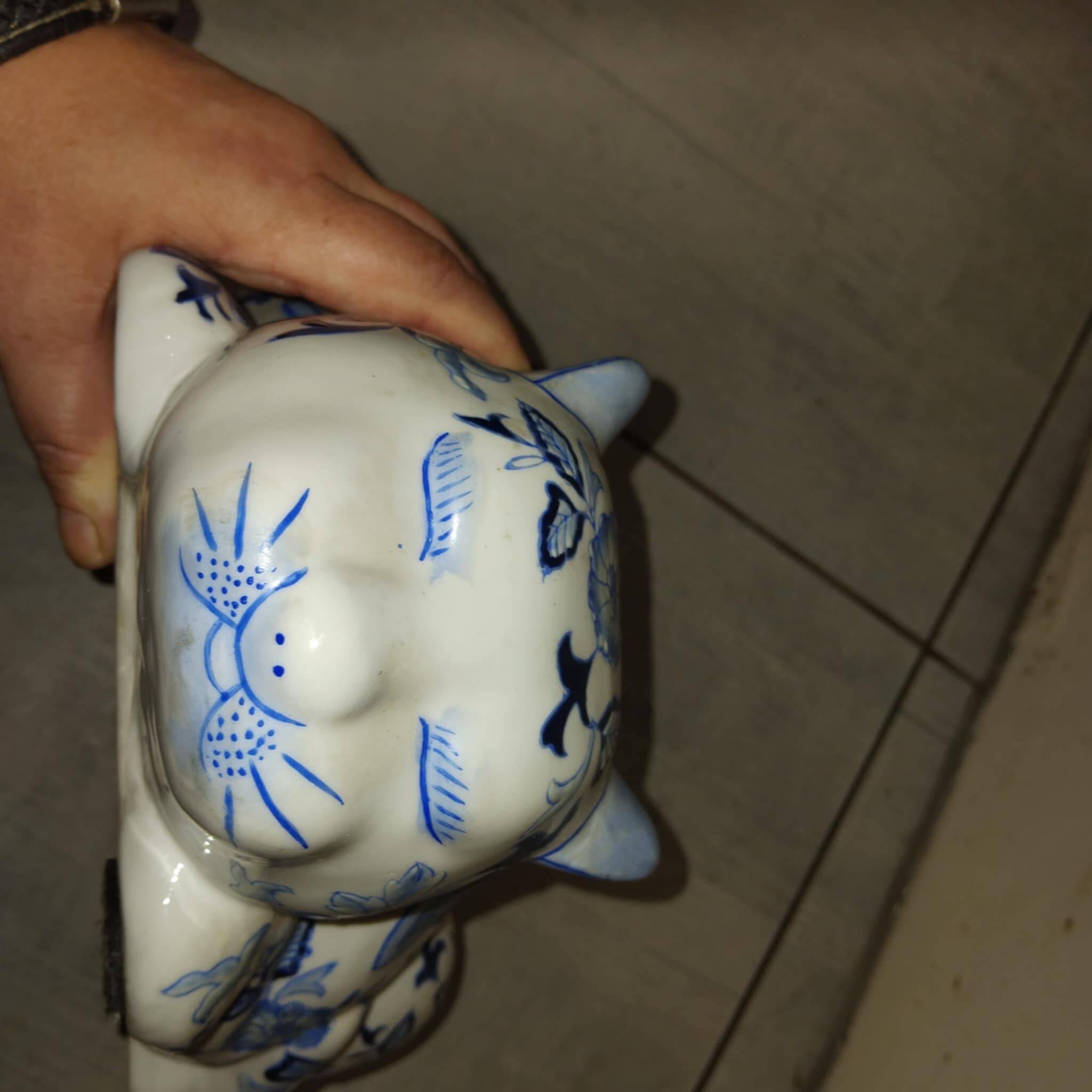 Vintage white and blue porcelain lying cat