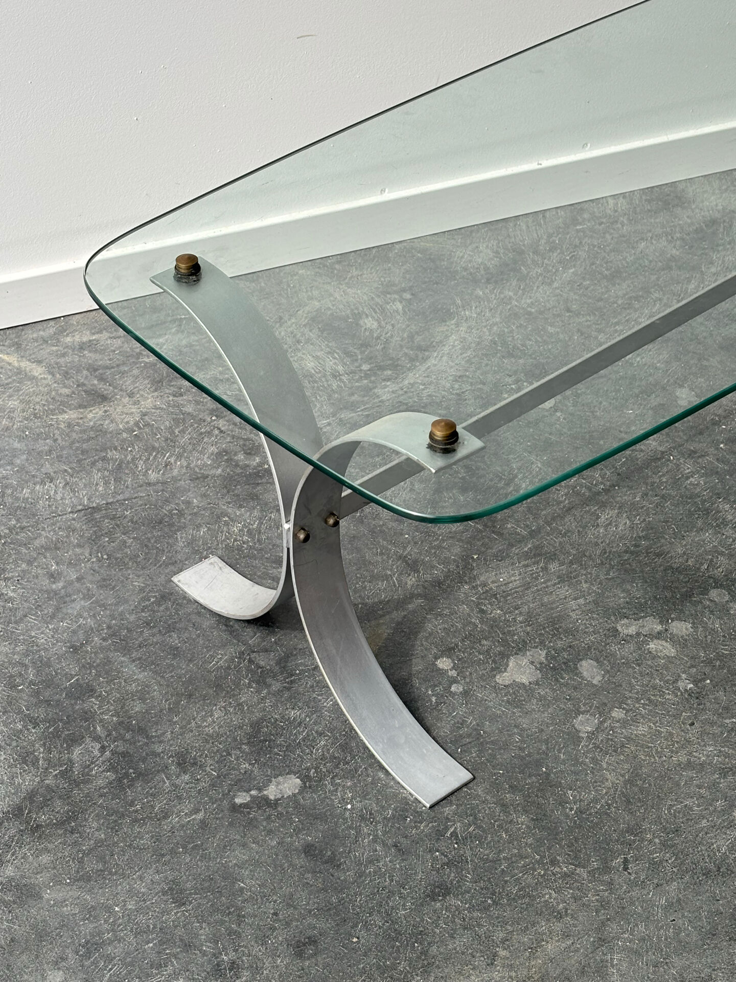Design coffee table in brushed metal with a glass top, 1970s.