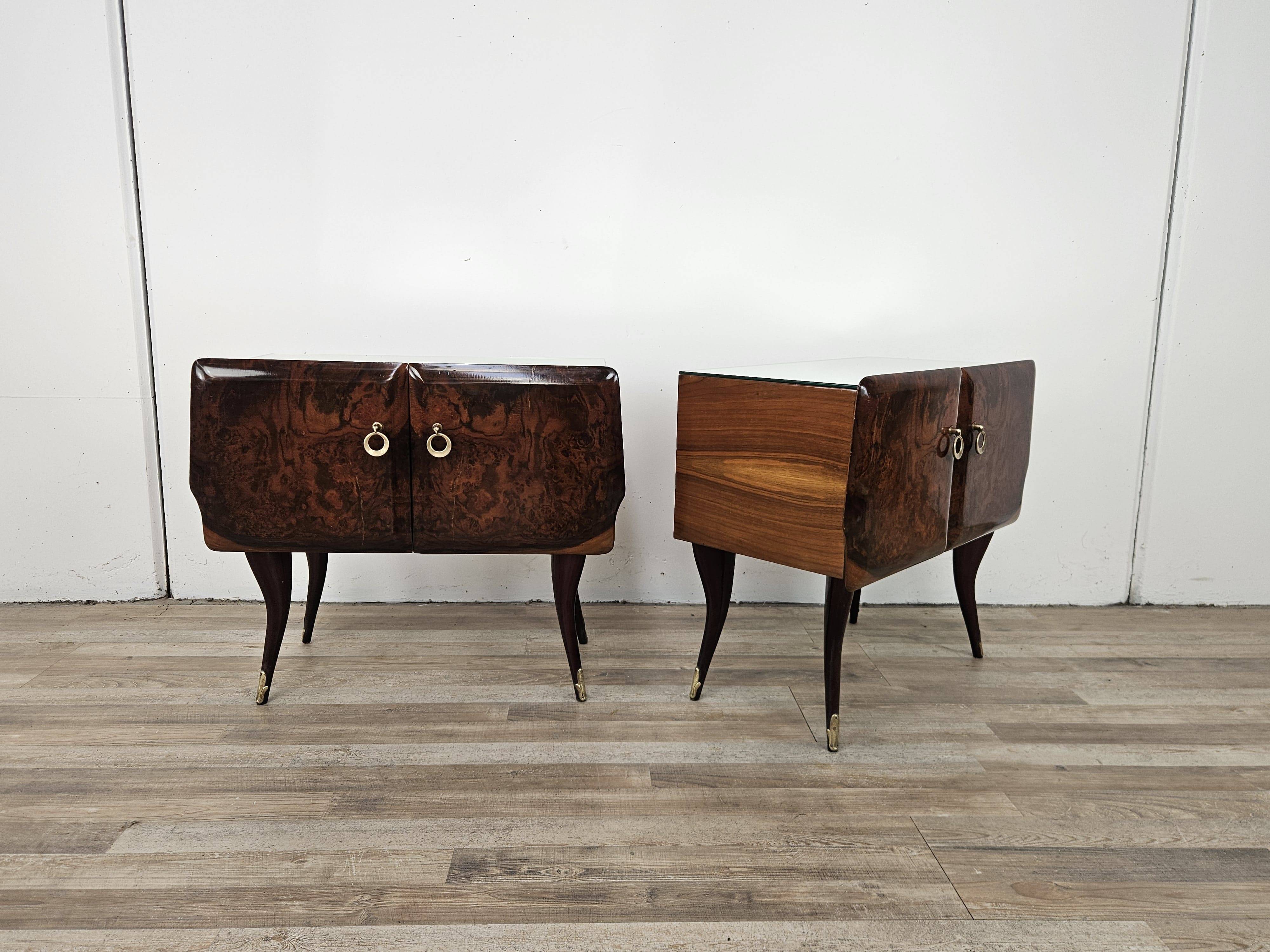 Mid-century mahogany bedside tables with mirrored tops.