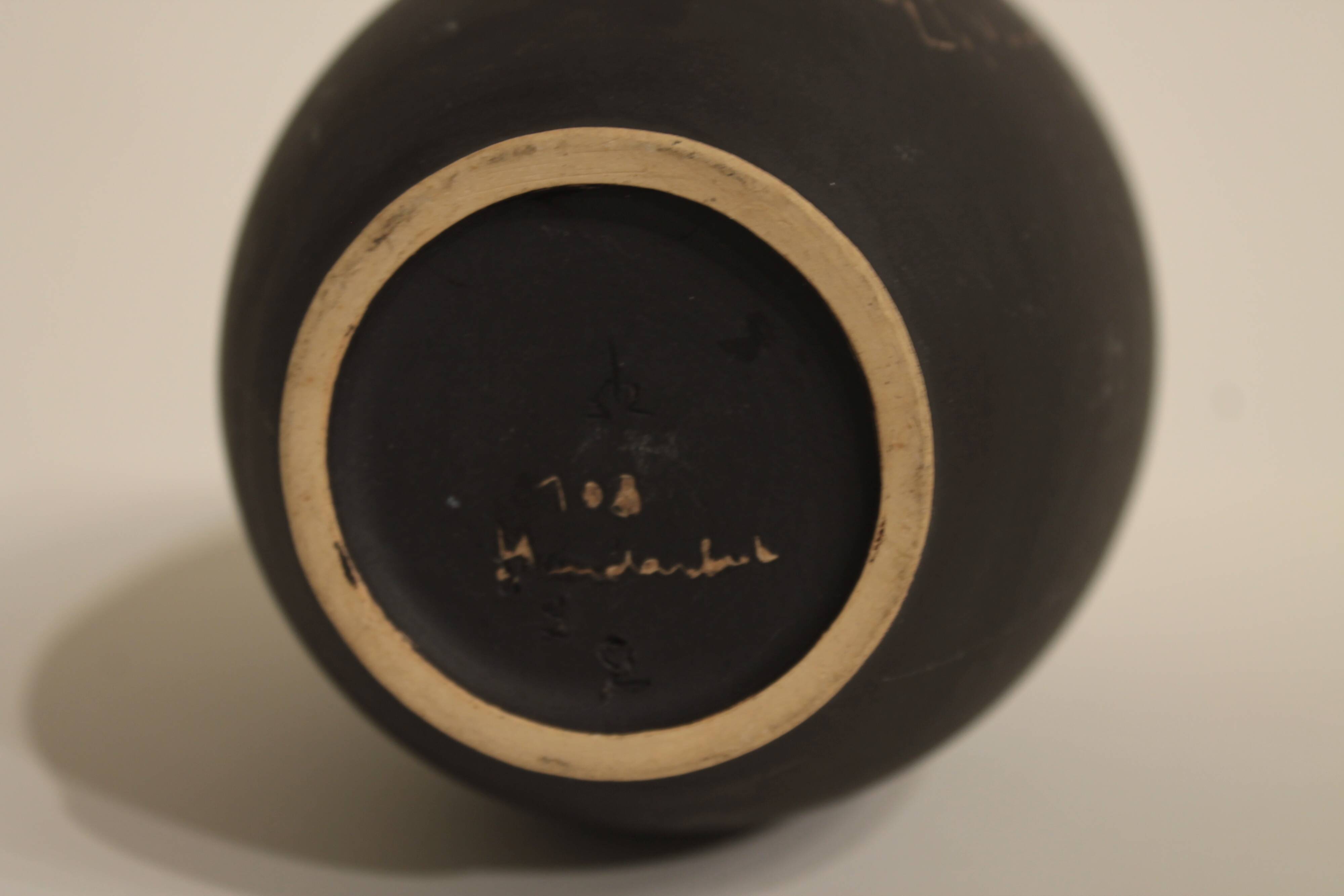 Ceramic vase decorated with women and a tree.