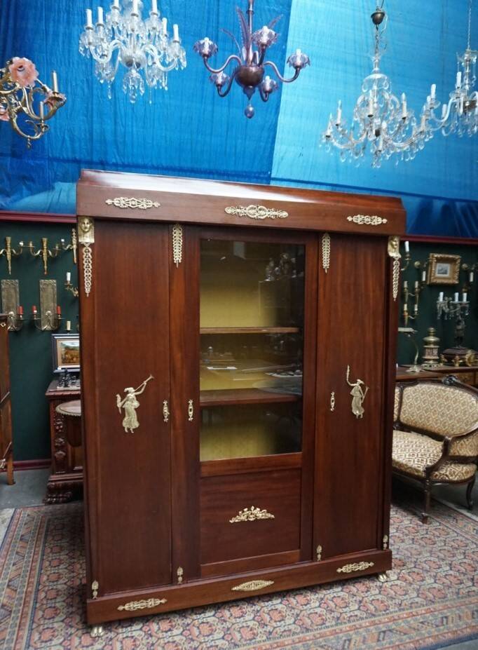 Empire style mahogany display bookcase with gilt bronze decoration and three doors.
