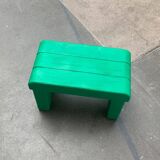 Postmodern plastic stool with a wood effect.