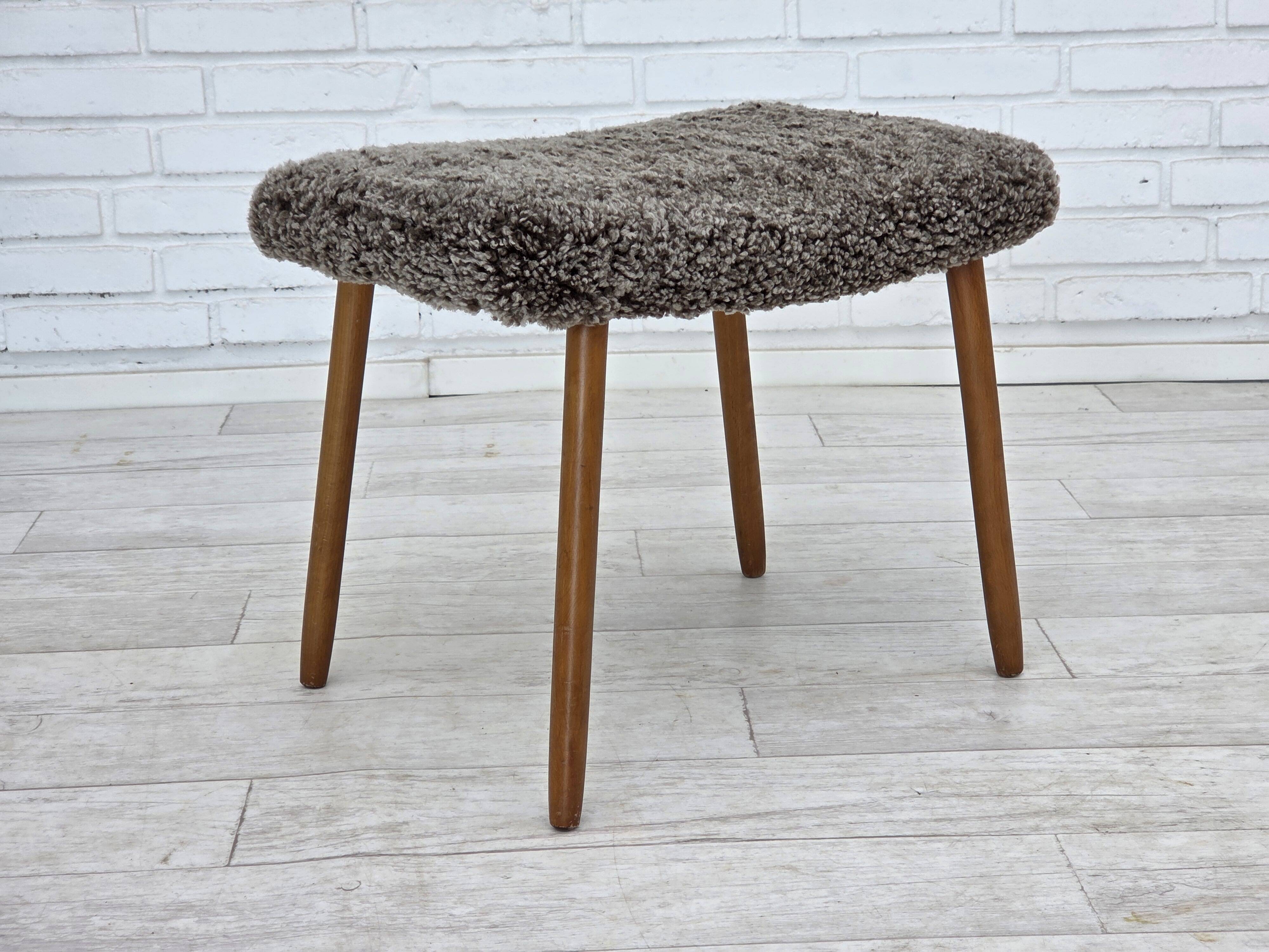 1960s, reupholstered Danish armchair, with stool, genuine sheepskin.