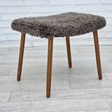 1960s, reupholstered Danish armchair, with stool, genuine sheepskin.