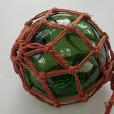Globe, green glass float and vintage rope