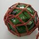 Globe, green glass float and vintage rope