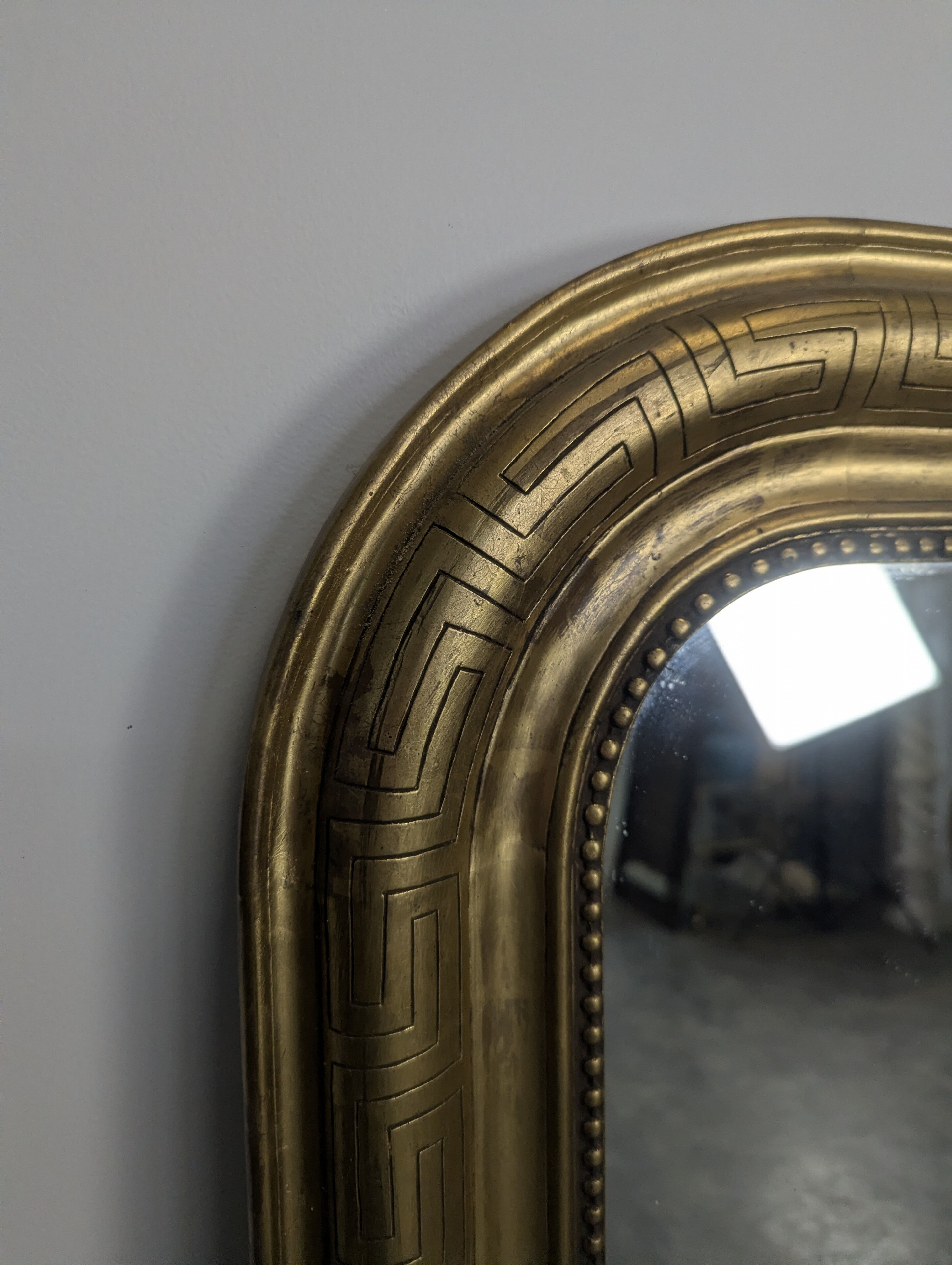 Golden wooden mirror with antique frieze from the Louis Philippe period.