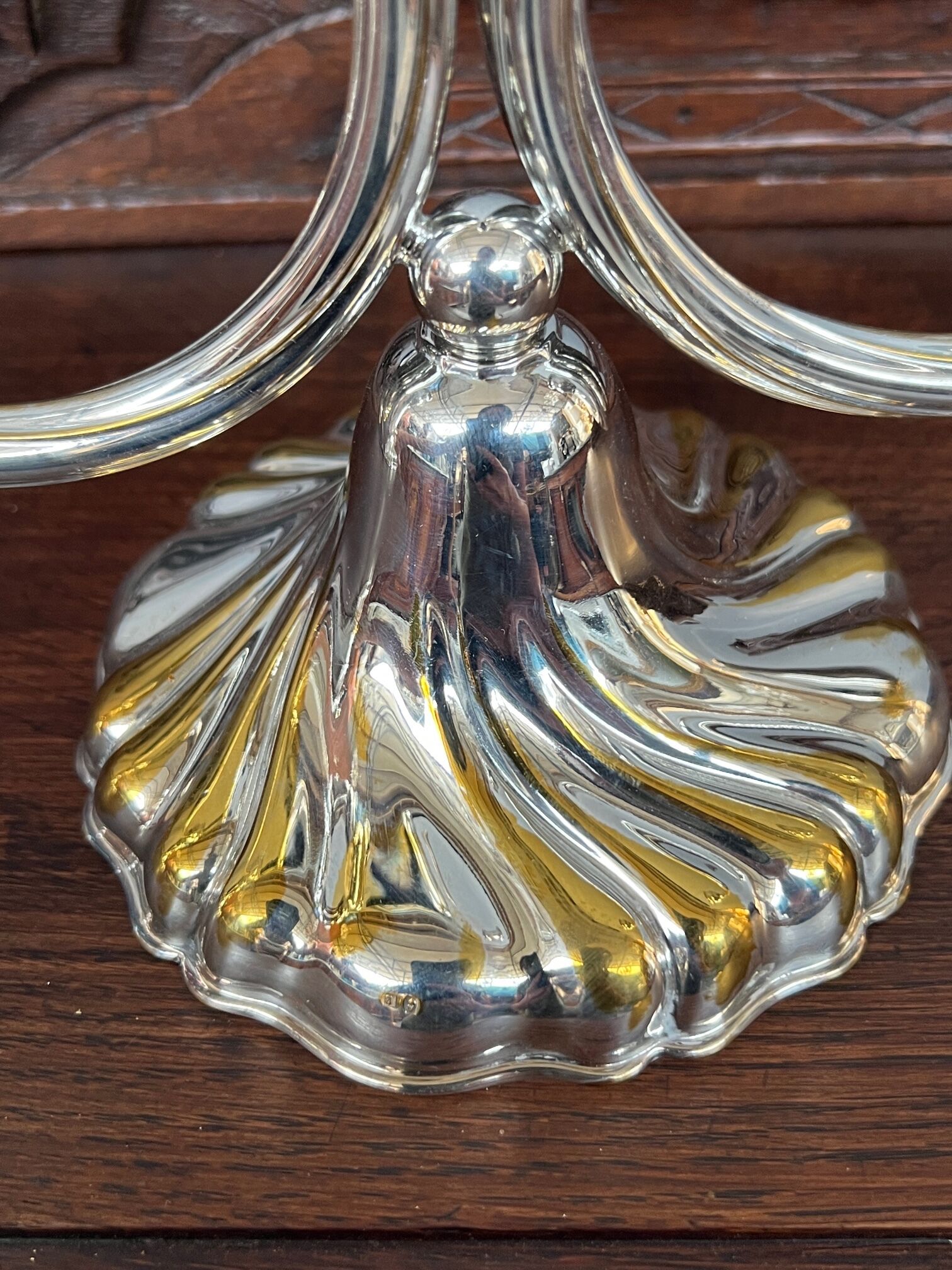 A pair of candlesticks. silver metal with gold decoration.