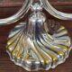 A pair of candlesticks. silver metal with gold decoration.