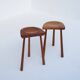 Set of two hand-carved wooden stools with sculpted seats