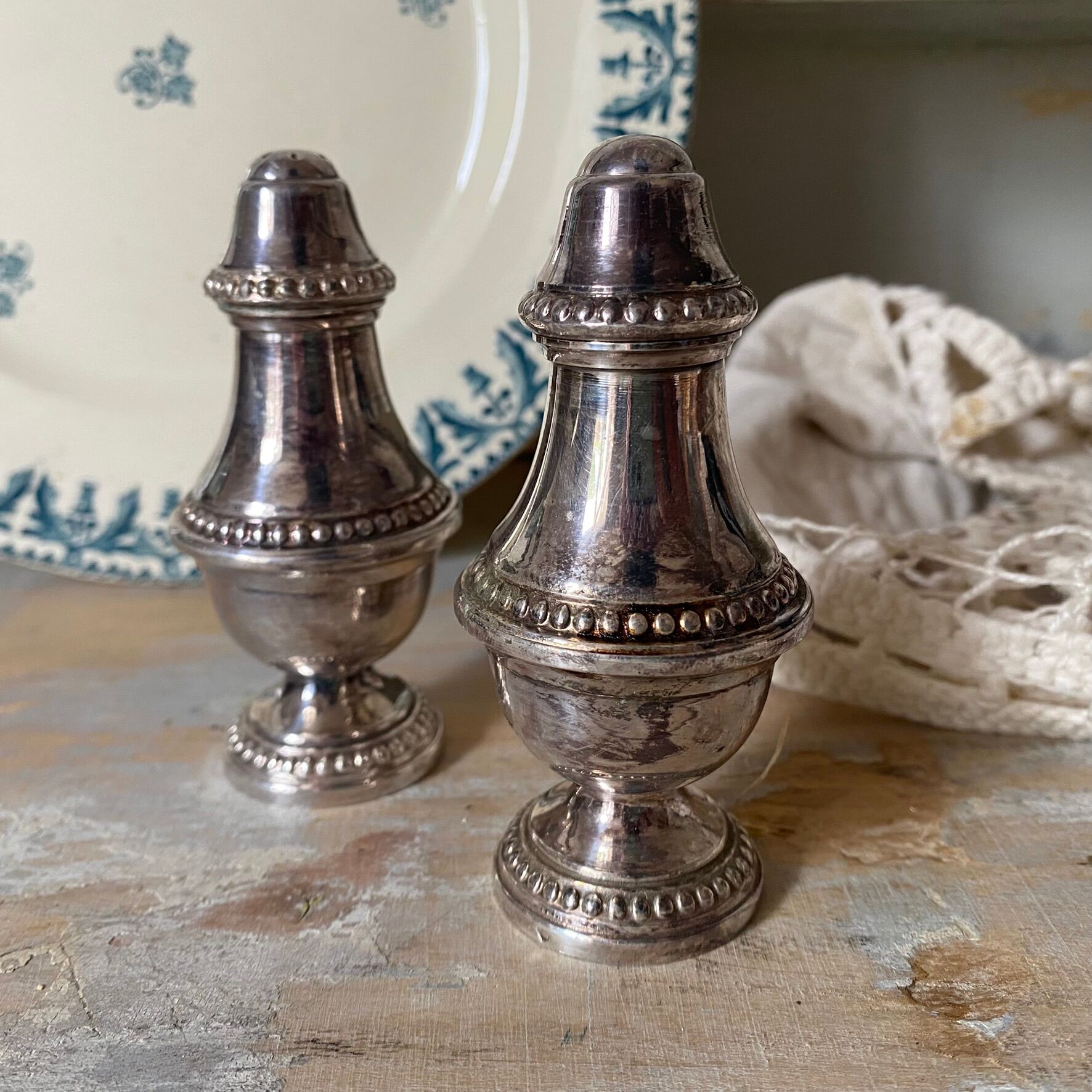 Silver-plated salt and pepper shakers, fluted, beaded decoration.