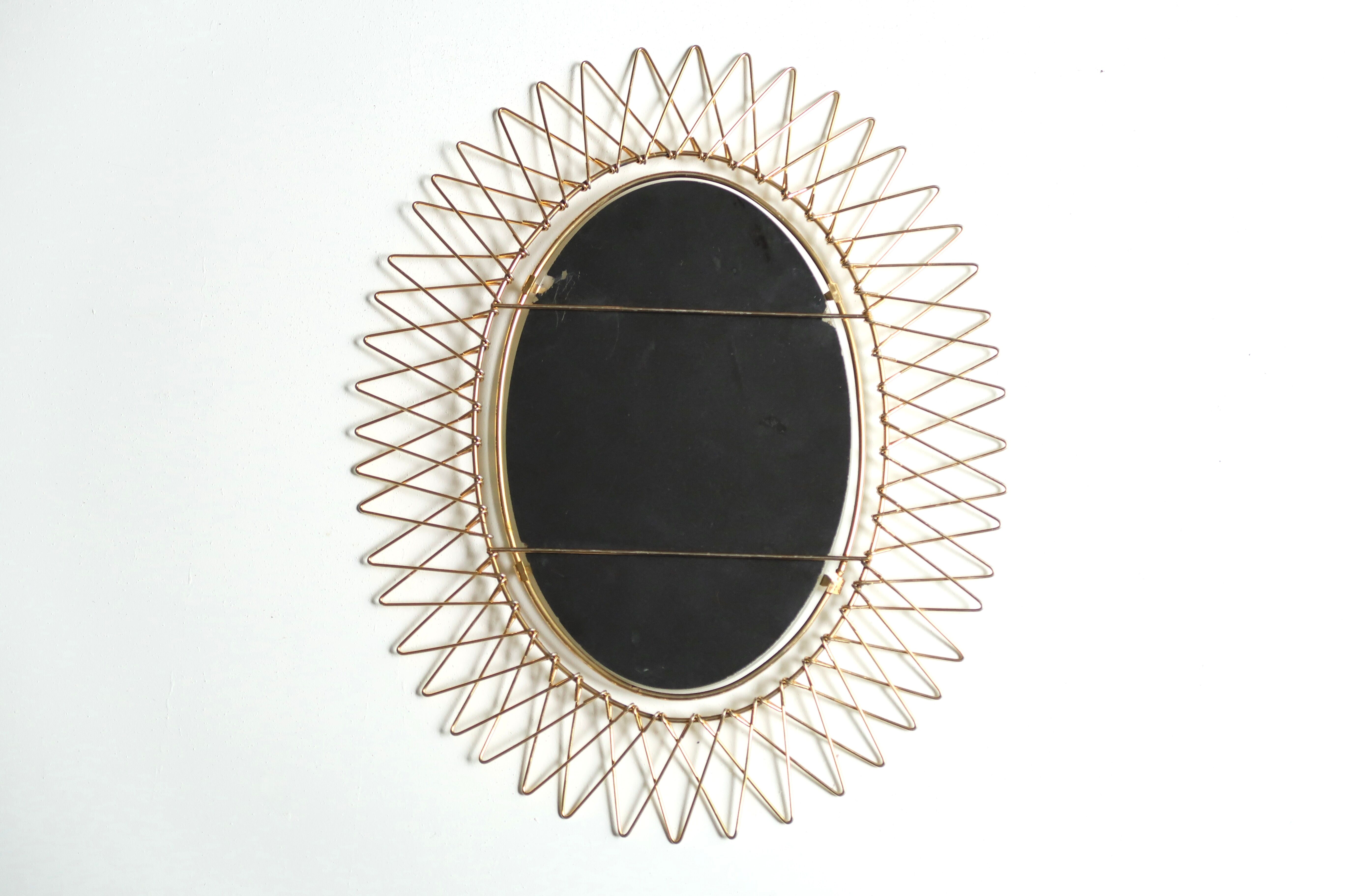 Oval golden sun mirror in metal, 1960s