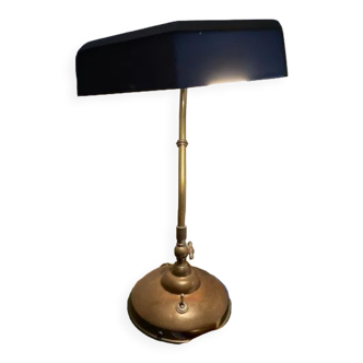 Antique swan neck table lamp with old-fashioned electric wire in operation and glass shade