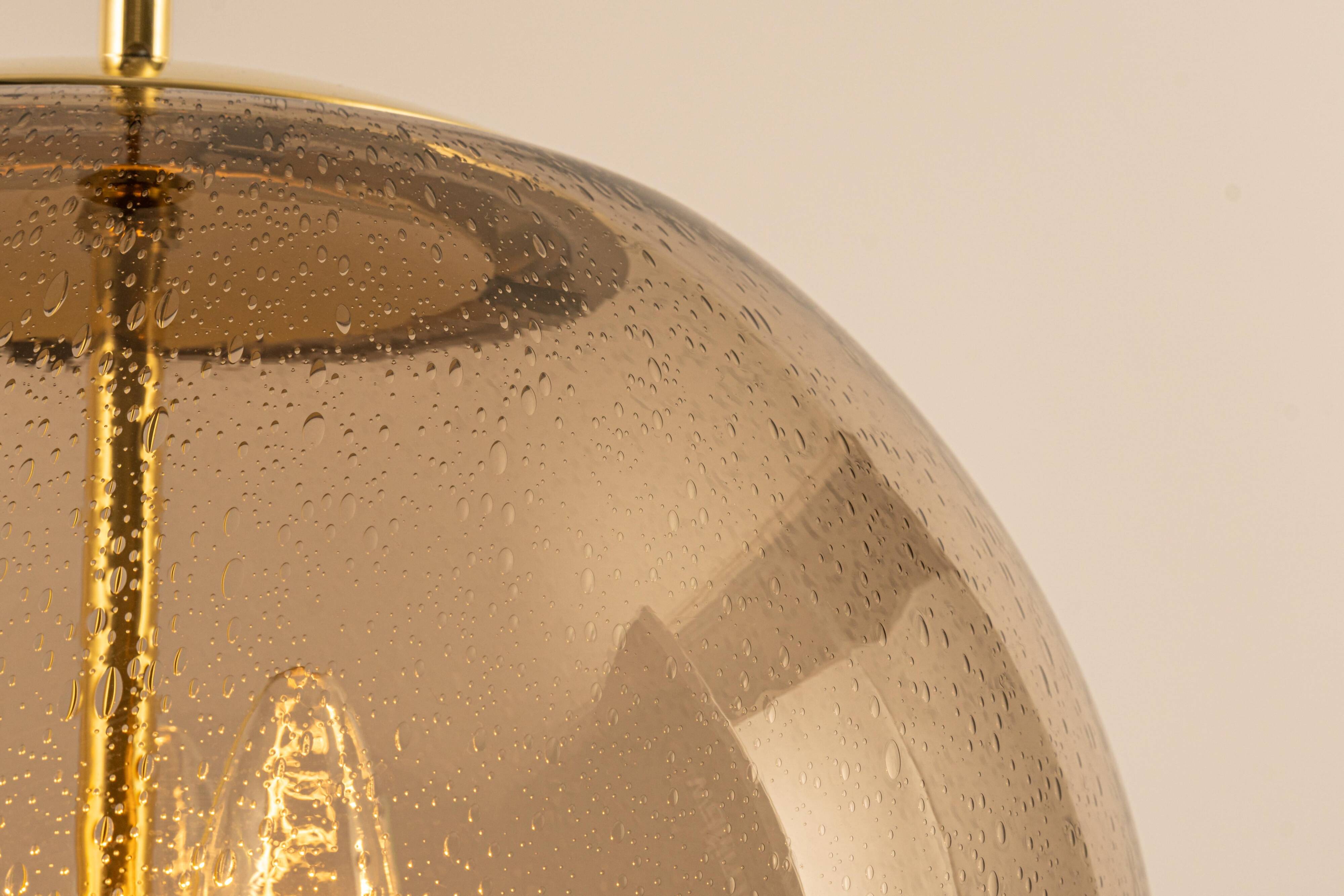 Large Limburg pendant light in brass with smoked glass ball, Germany, 1970s.