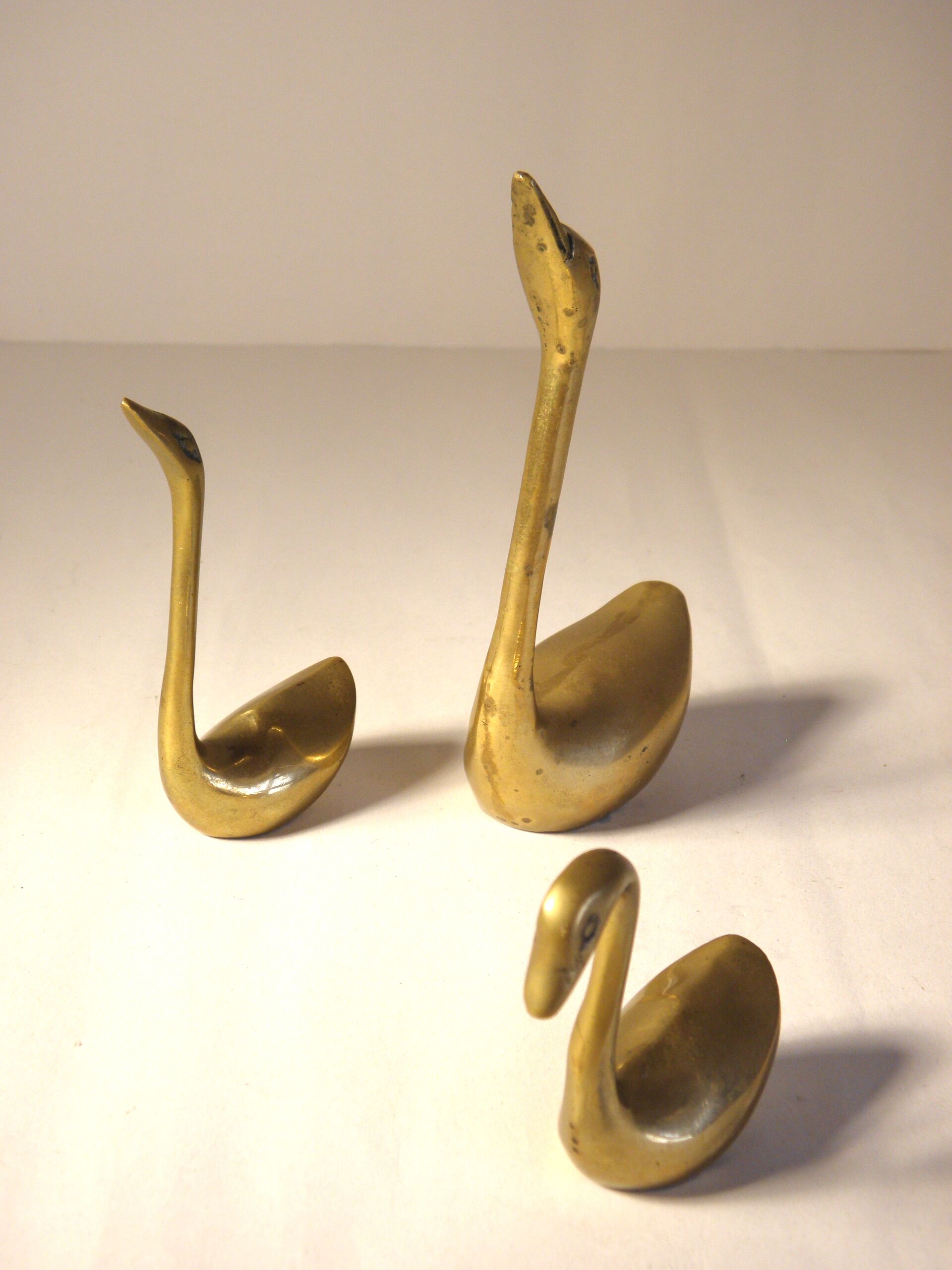 Trio of brass swans