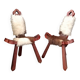 Pair of brutalist tripod chairs in wood and cowhide