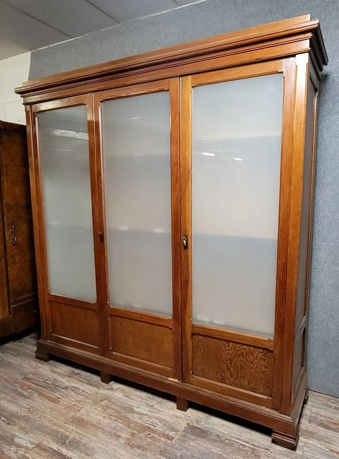 Large pine bookcase with three doors, fitted with frosted glass.