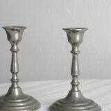 Pair of small metal candle holders, classic design.