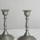 Pair of small metal candle holders, classic design.