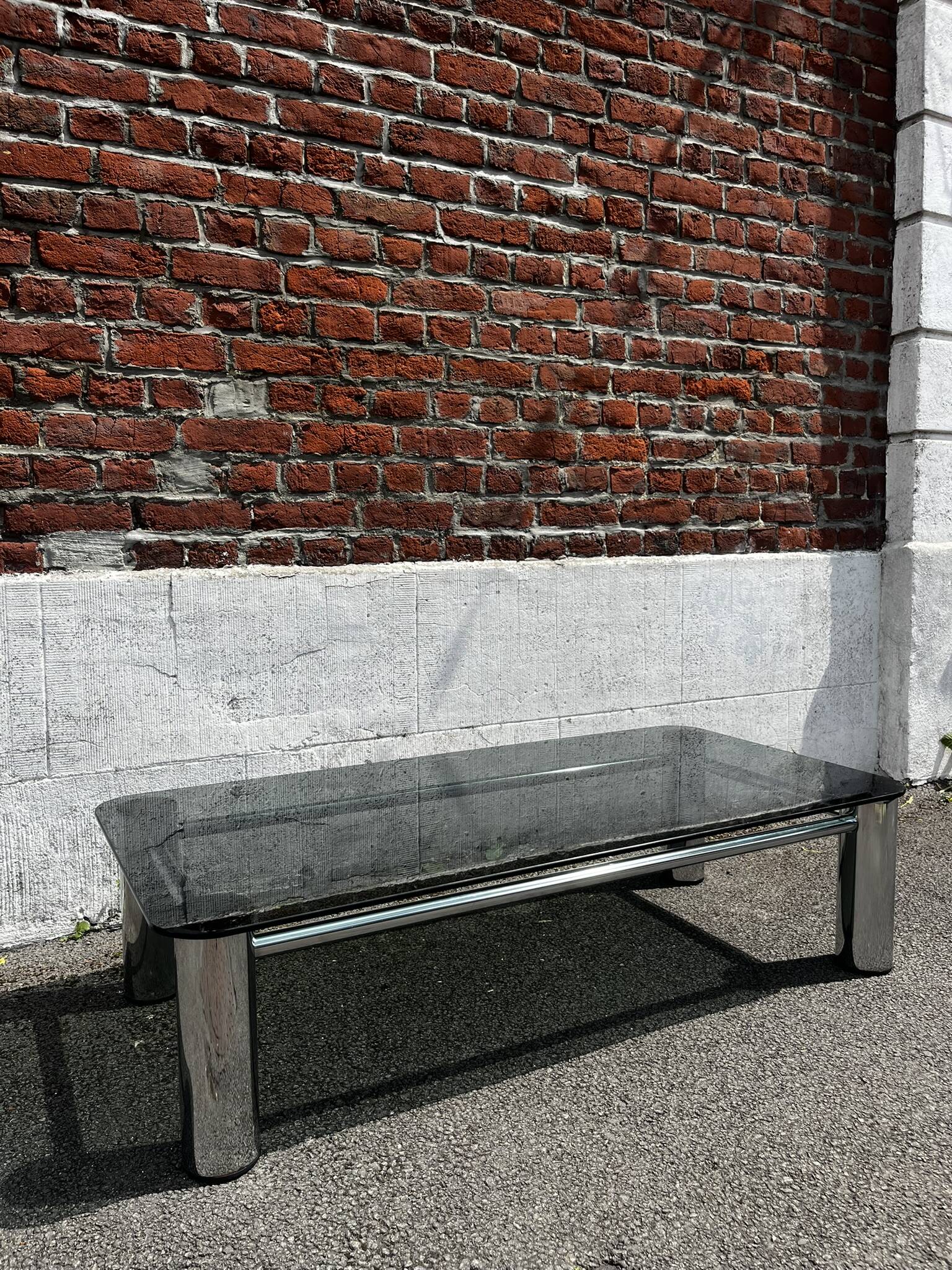 Vintage coffee table with smoked glass and chrome.