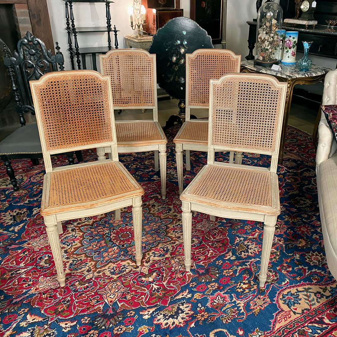Set of four grey lacquered wooden chairs in the Louis XVI style, late 19th century.