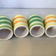Four striped egg cups in yellow and green.