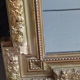 Antique mirror in wood and gilded stucco, neo Louis XVI style.