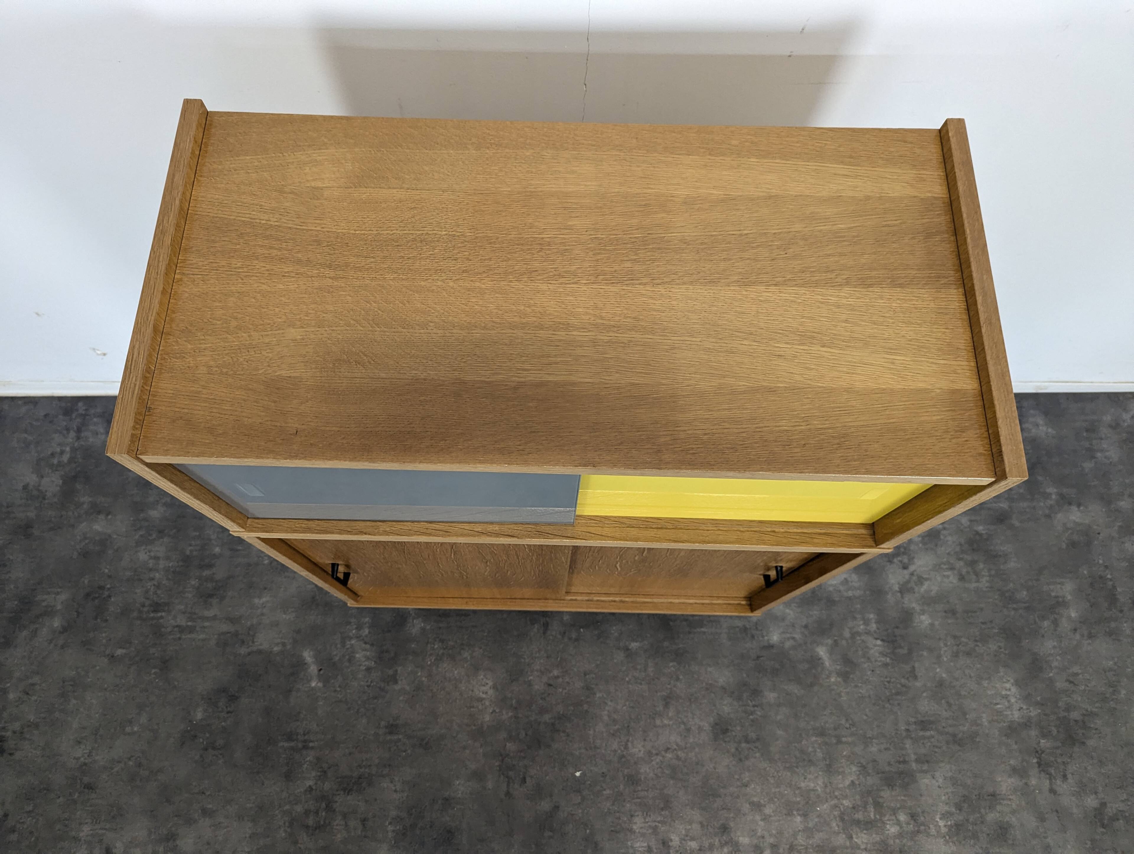 Modernist sideboard with glass doors in grey and yellow oak veneer.