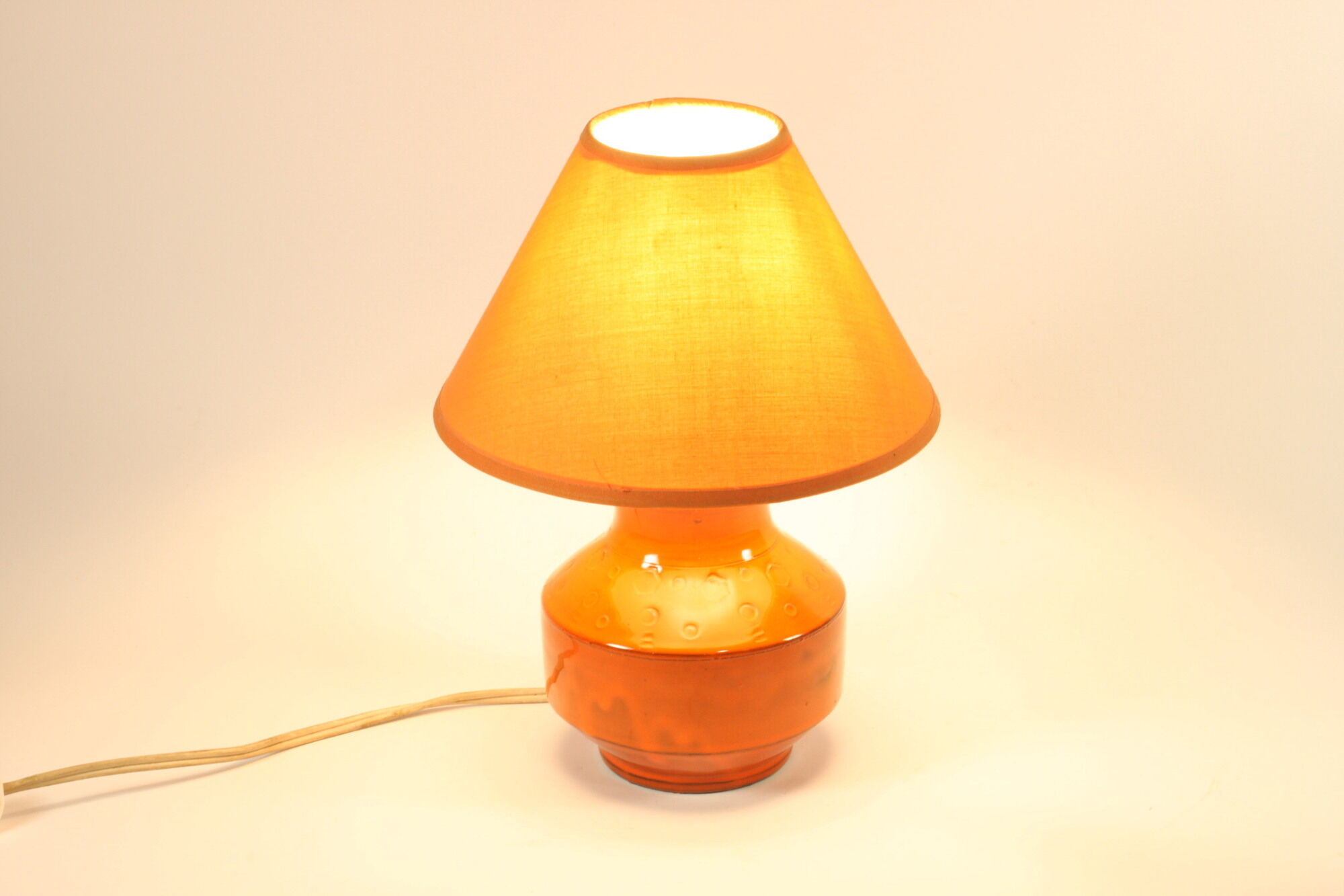 Orange ceramic table lamp with geometric imprints, 1970s.