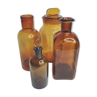 Set of four amber glass apothecary bottles, ancient