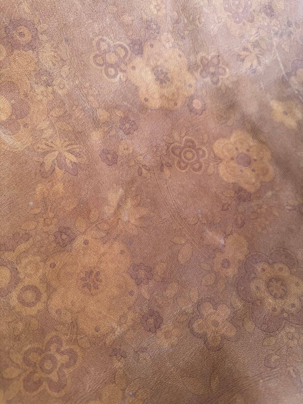 19th-century dark brown wrought-metal rocking chair with cognac leather sling seat, vintage