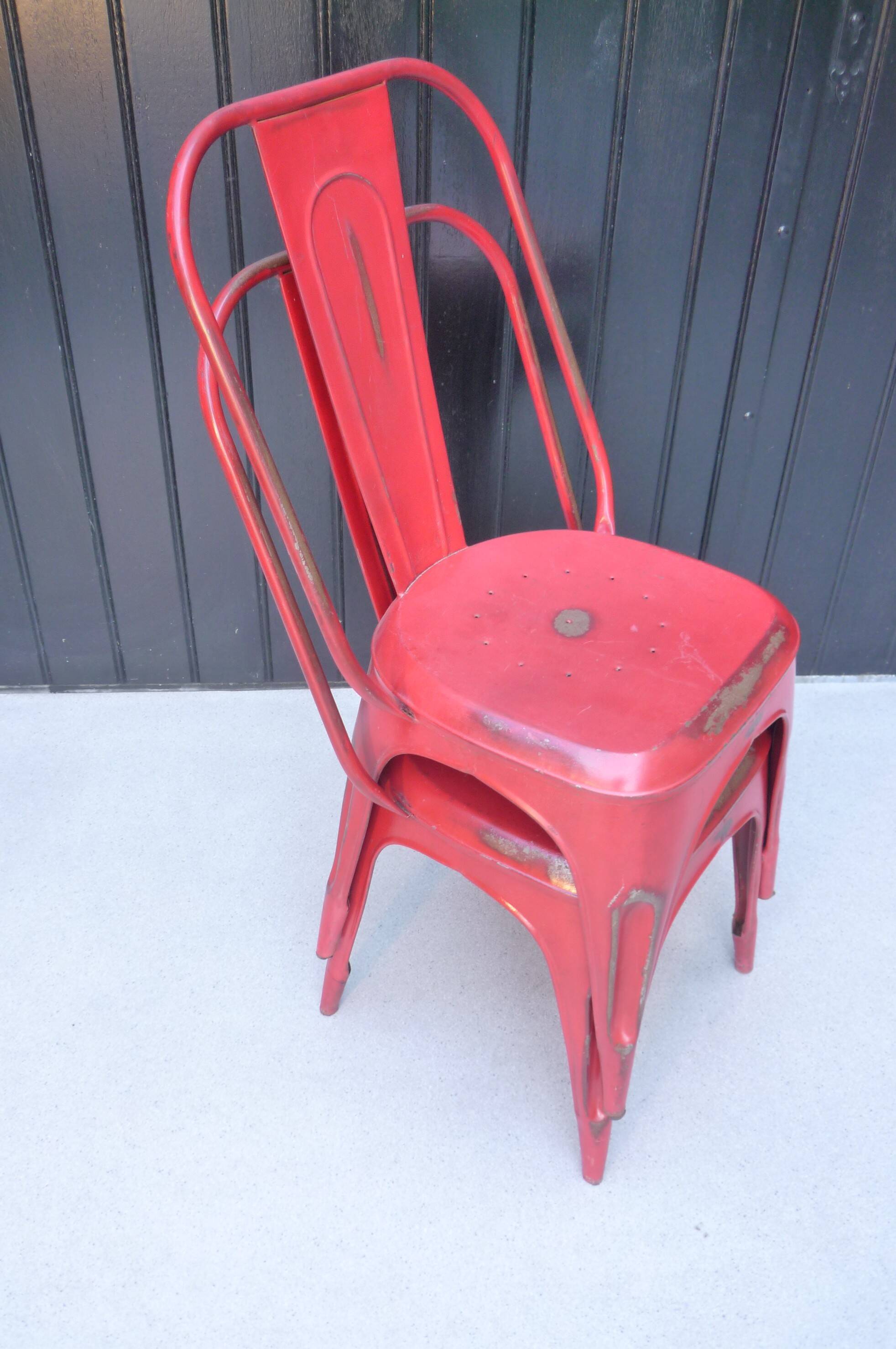 Pair of red stackable metal chairs