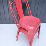 Pair of red stackable metal chairs