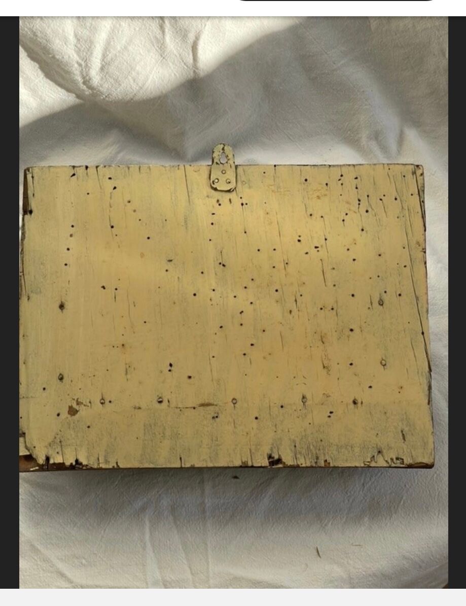 Hammered leather wall mail holder on wood.